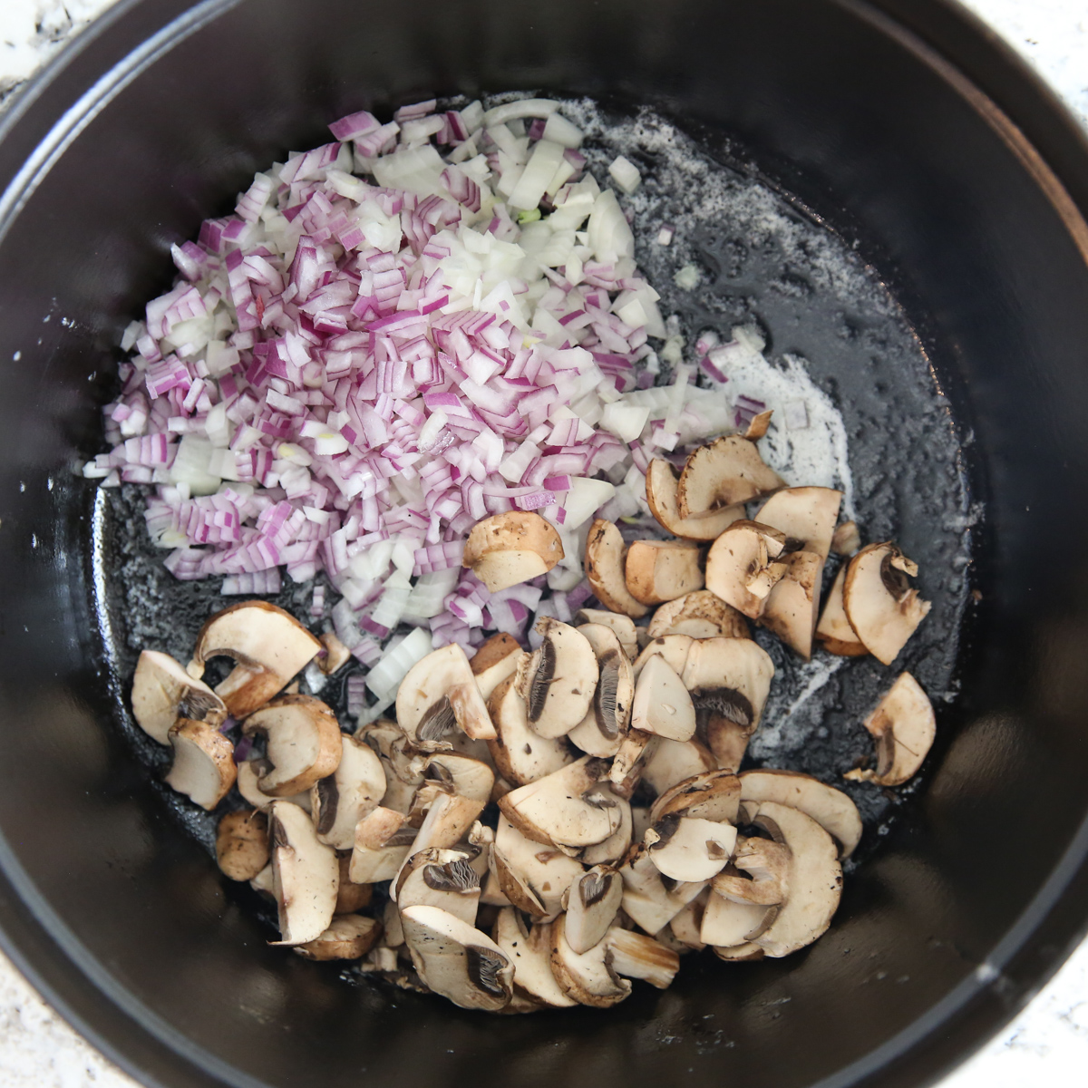 onion and mushrooms in a stock pot