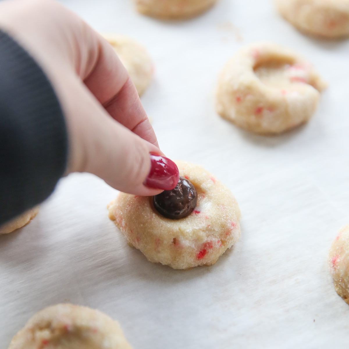 placing a junior mint on a candycane cookie