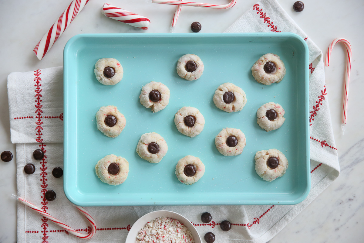 aqua colored baking sheet with candy cane cookies on top