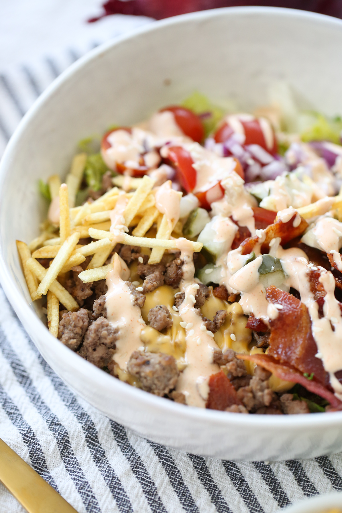 close up of a bacon cheeseburger salad bowl with all the toppings