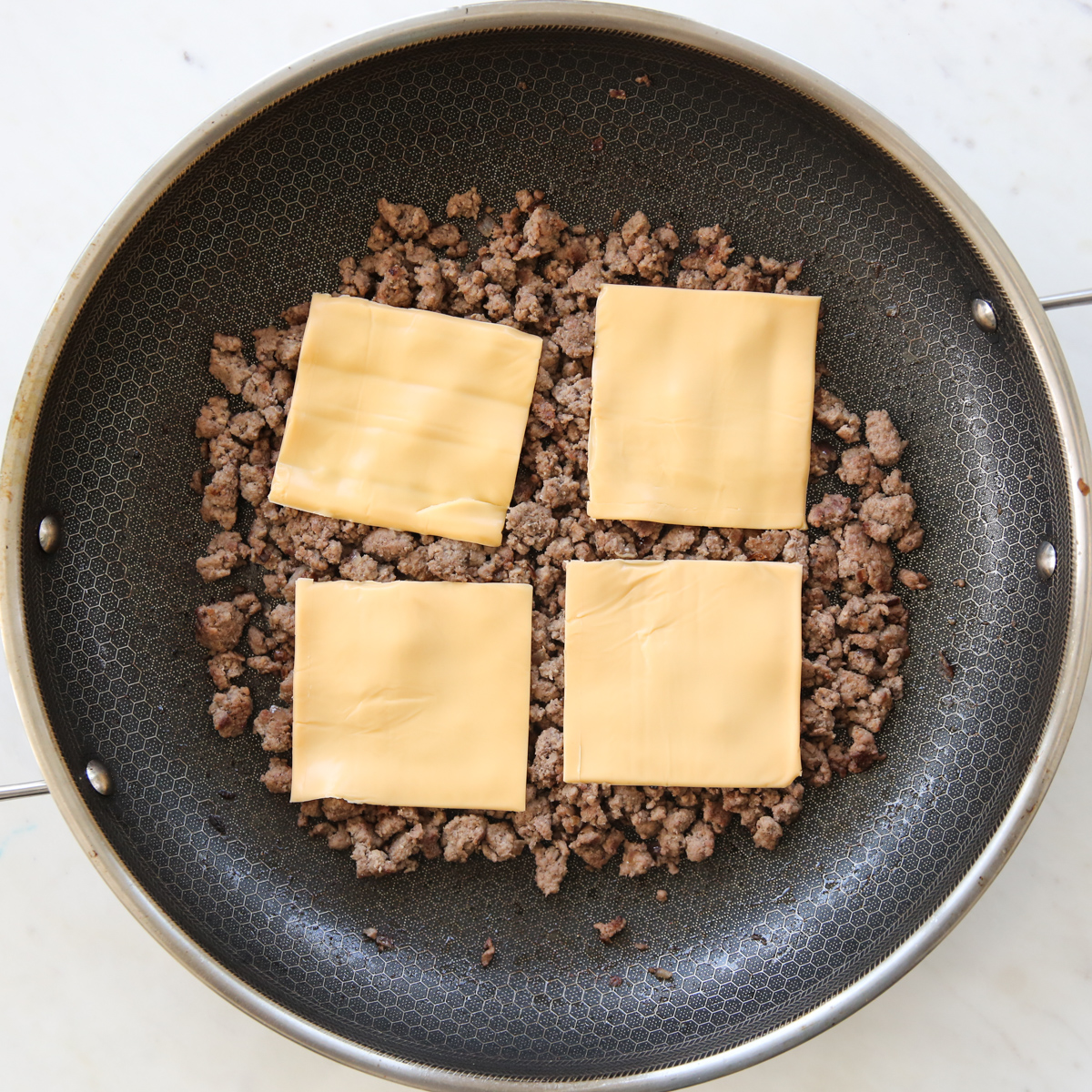 ground beef with american cheese on top