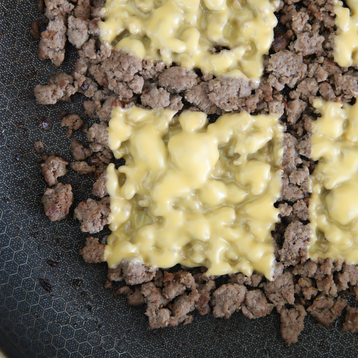 melted american cheese over ground beef