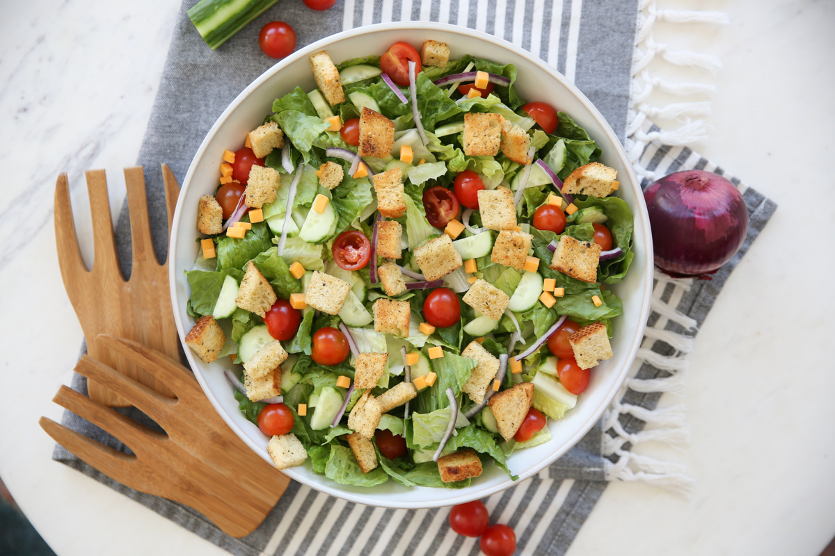 House salad in a white salad bowl on a kitchen towel