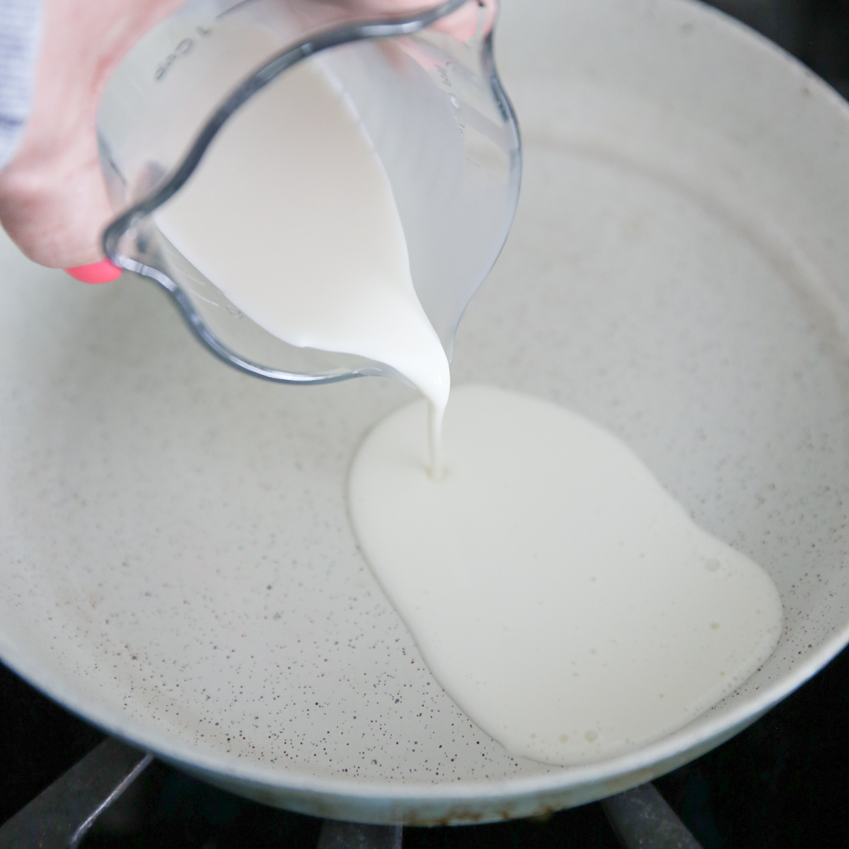 pouring cream into pan