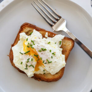 cream fried egg on toast with chives