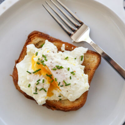 cream fried egg on toast with chives
