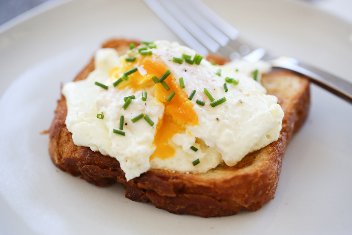 cream fried egg on toast with chives