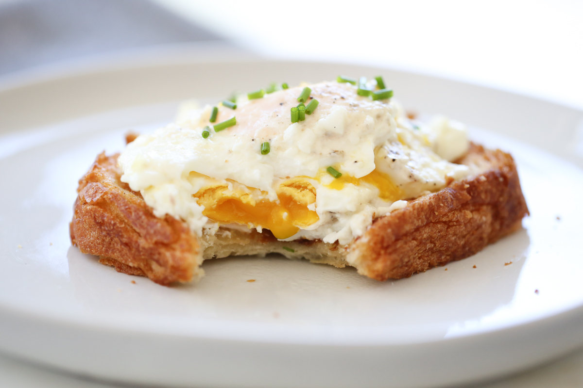 cream fried egg on toast with chives