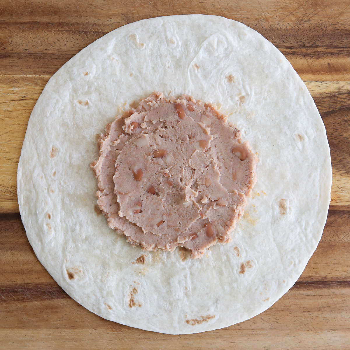 refried beans on a tortilla