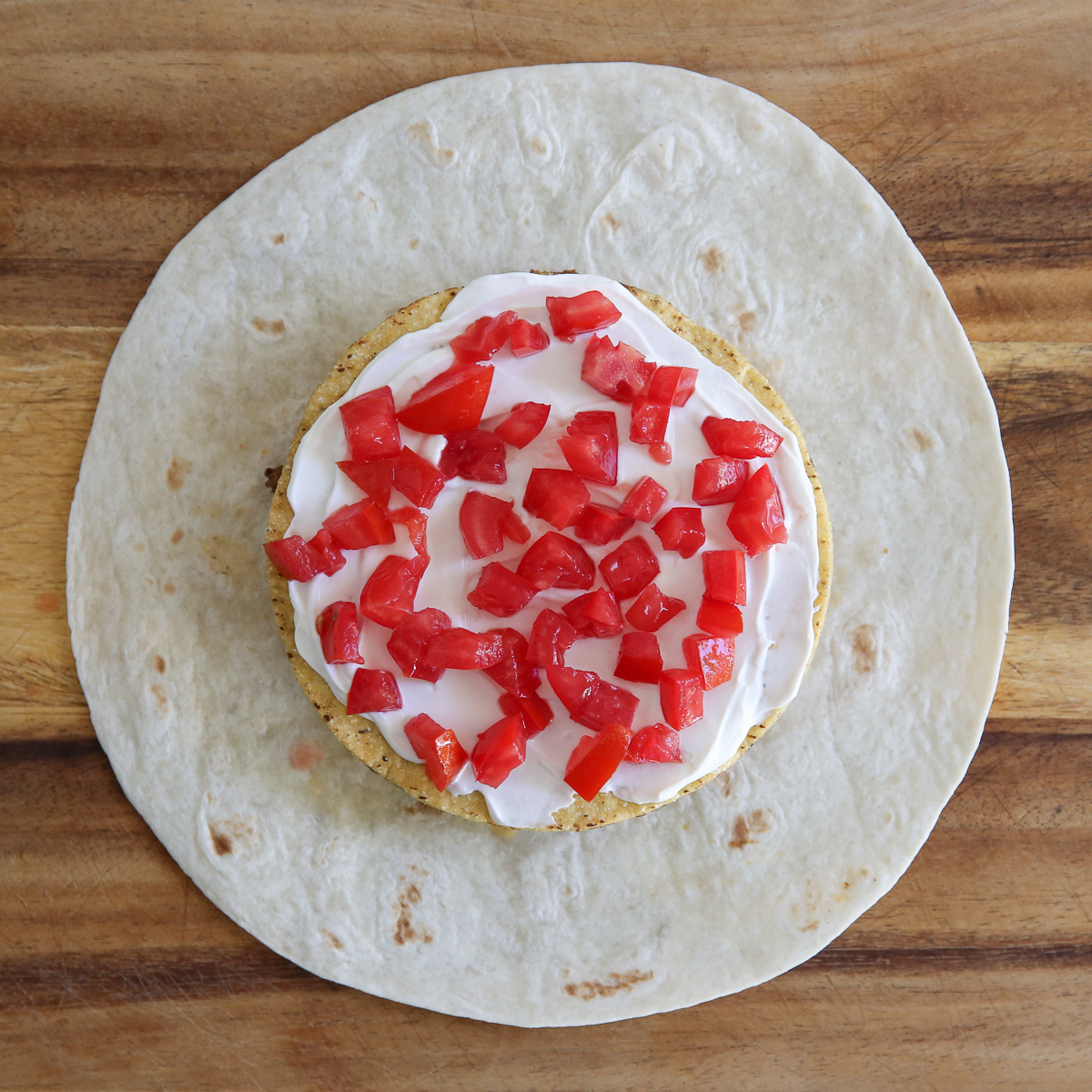 diced tomatoes on a crunch wrap supreme