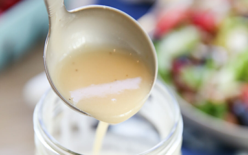 Honey Lemon Vinaigrette being poured
