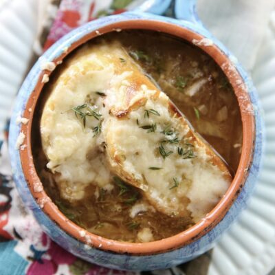 french onion soup in a bowl with crostini on top