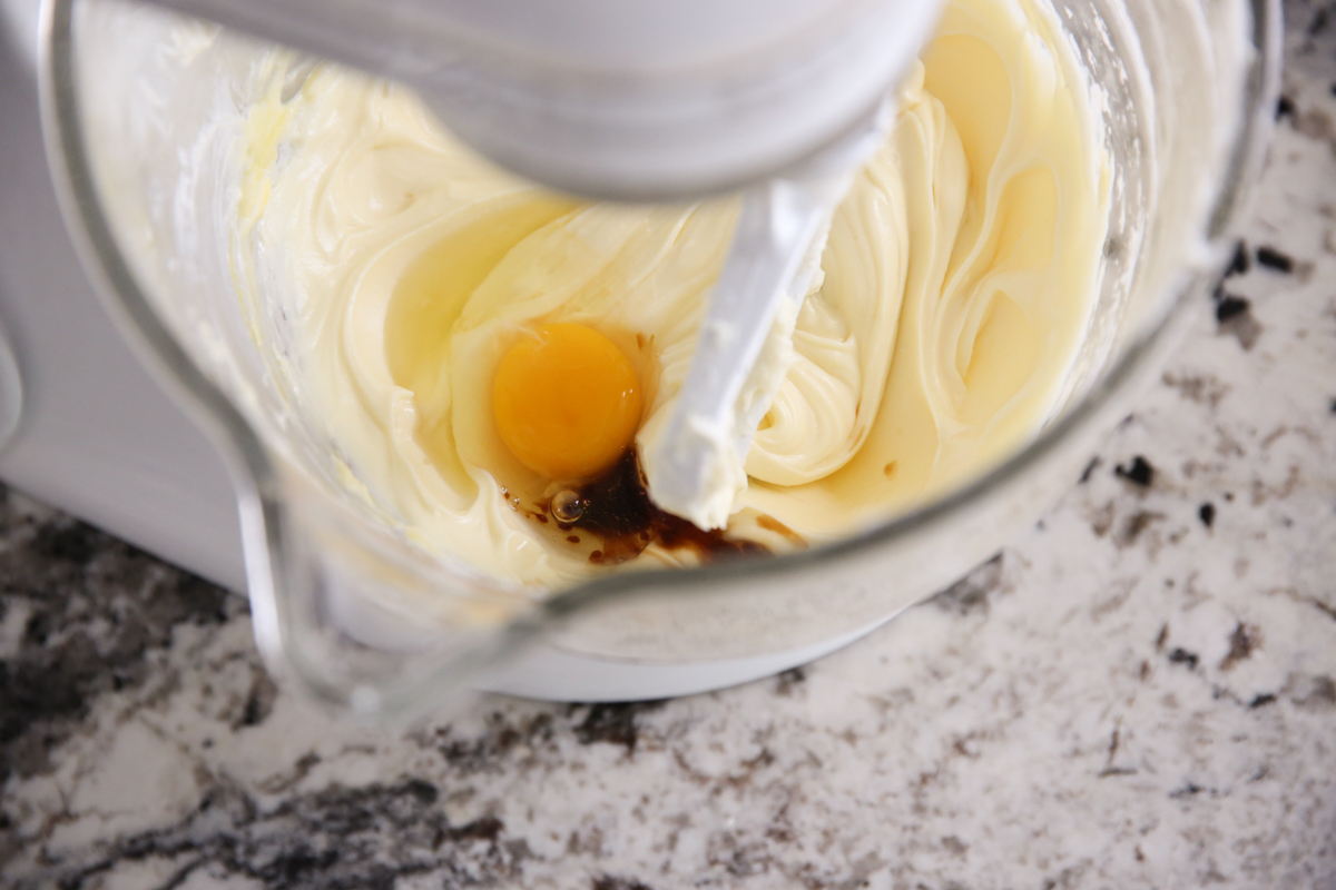 cheesecake batter mixing in a stand mixer