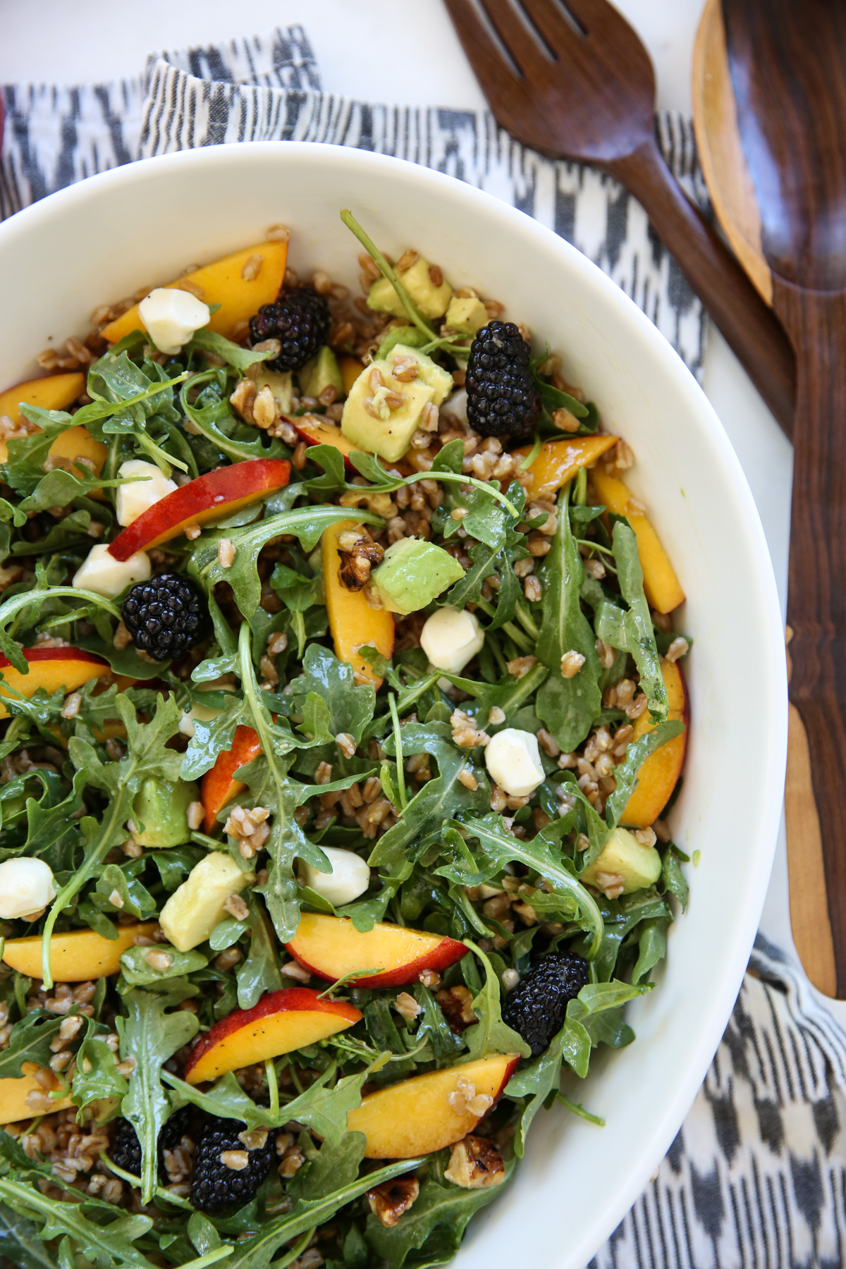 peach arugula salad in a white salad bowl