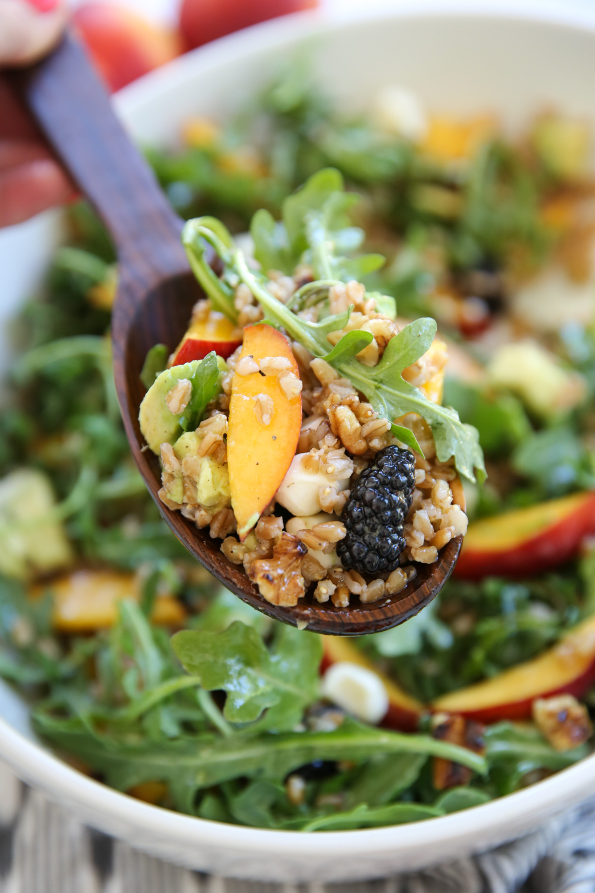 Peach Arugula Salad in a white bowl
