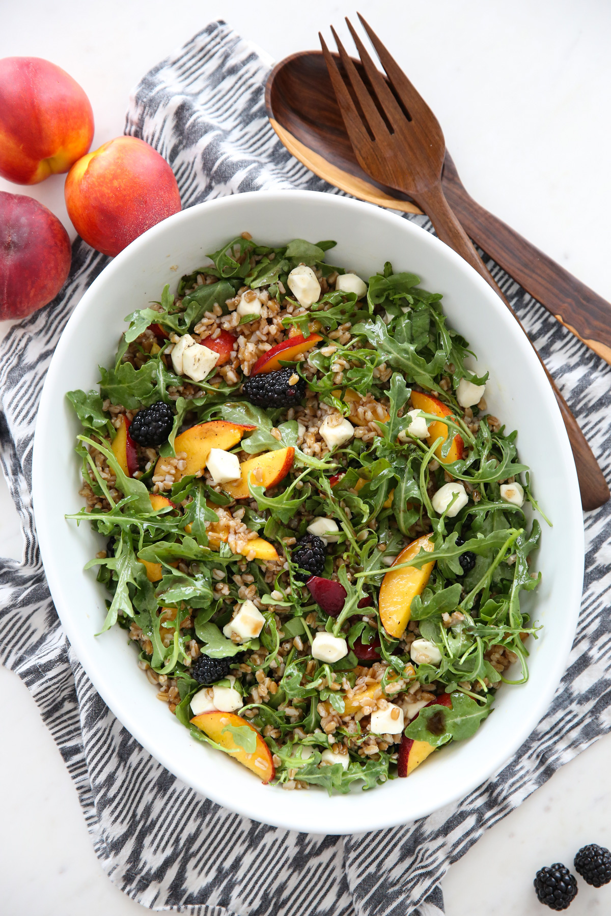 Peach Arugula Salad in a white bowl