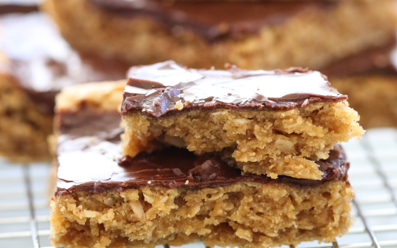 stacked peanut butter cookie bars on cooling rack