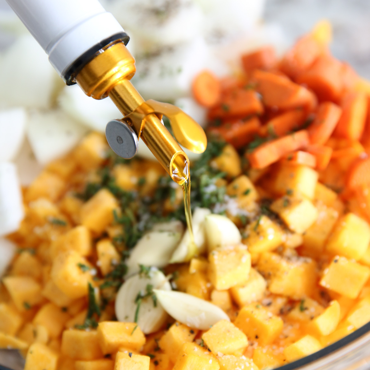 pouring olive oil onto veggies