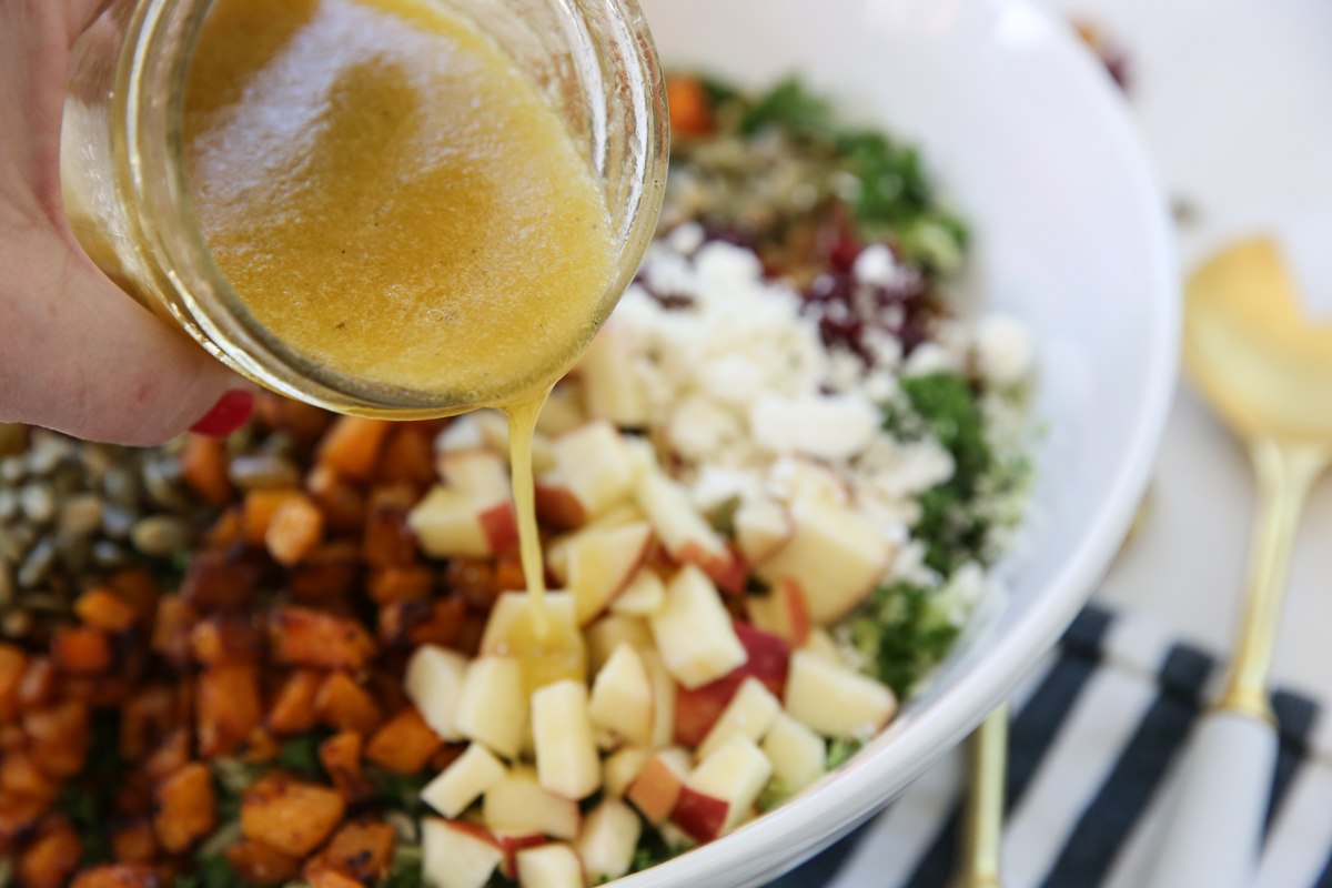 pouring dressing over salad
