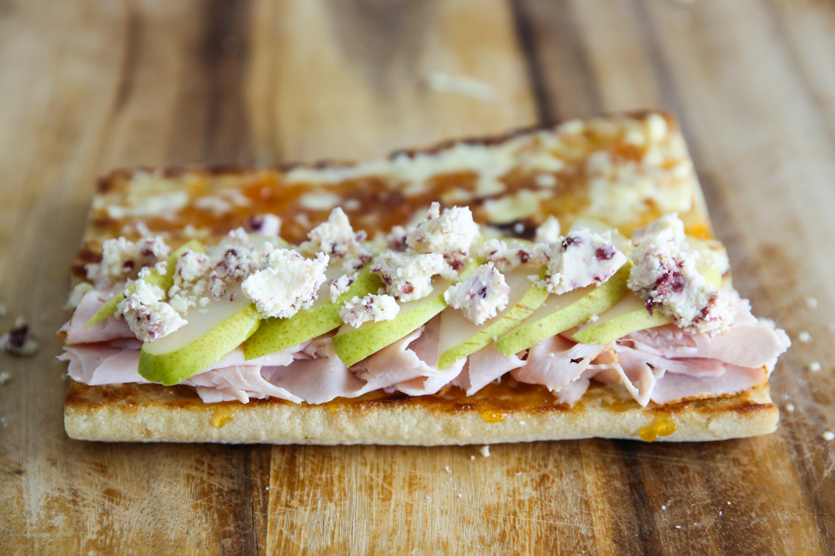 building a turkey sandwich on a cutting board