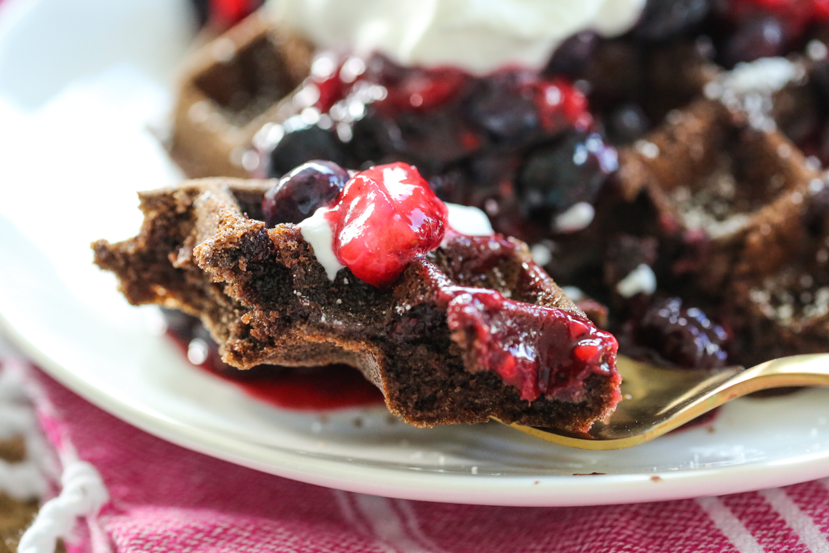 Chocolate Waffles with whipped cream and berries on a plate